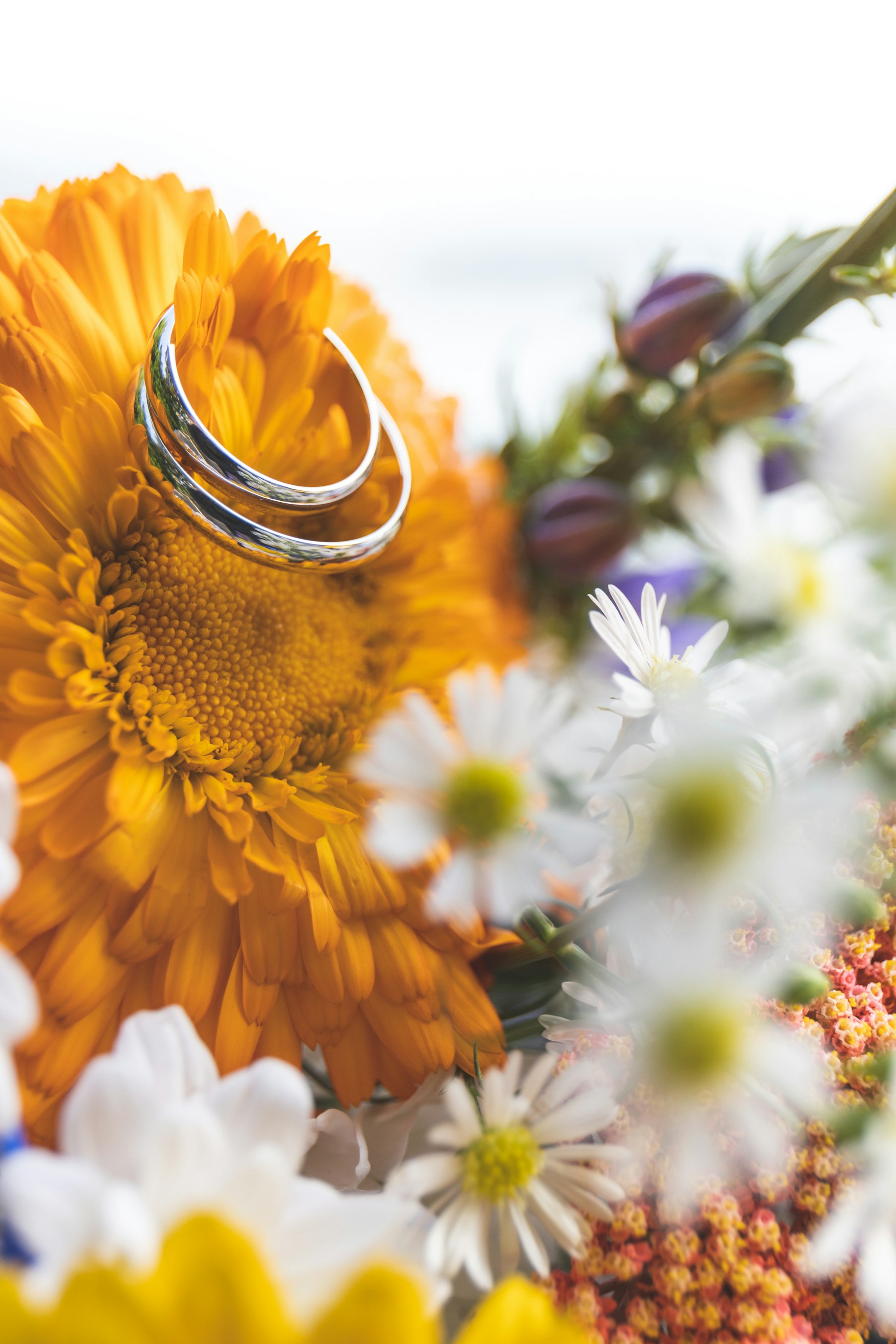 Wedding ring resting among fresh flowers