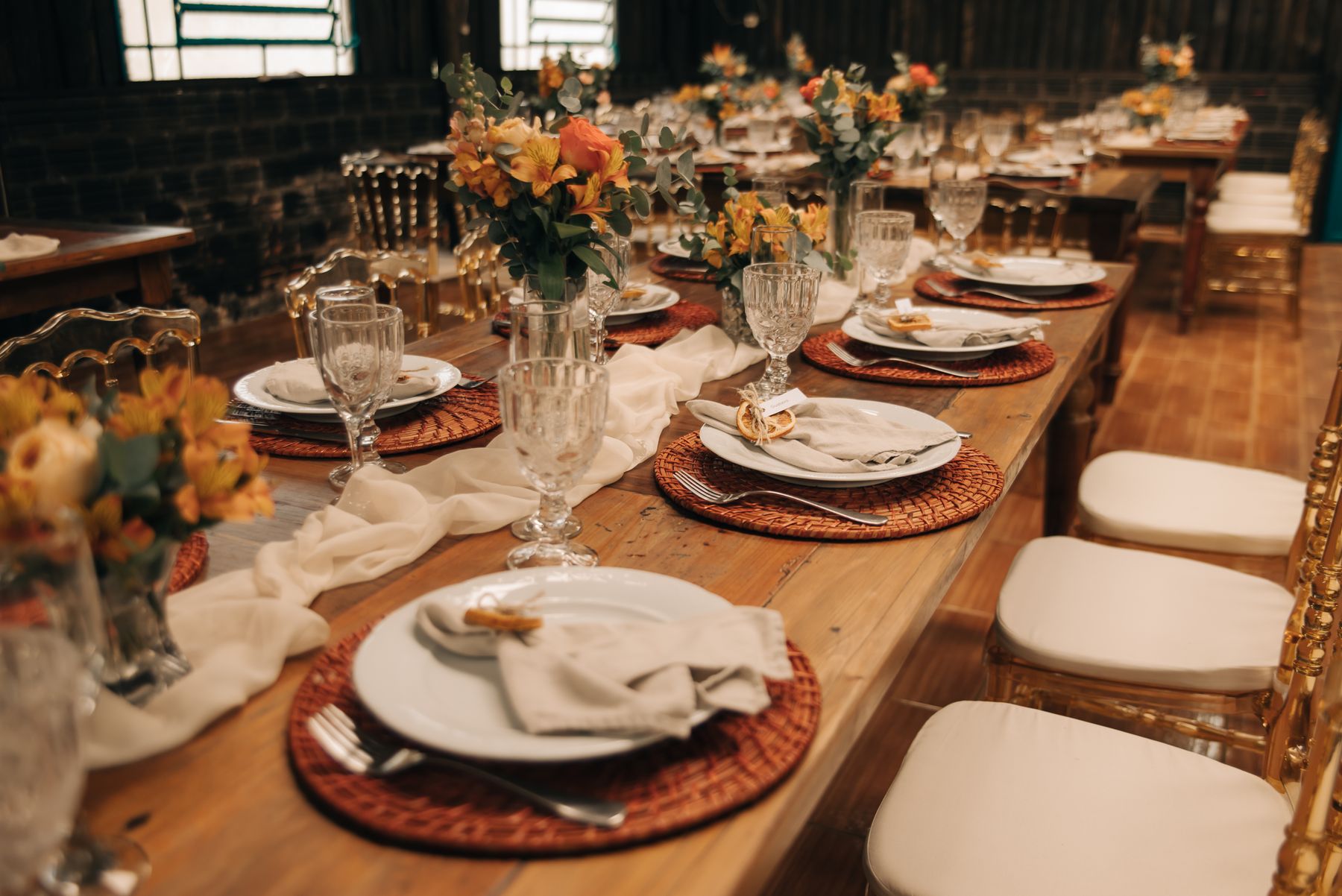 Wedding reception table arranged with flowers and elegant place settings