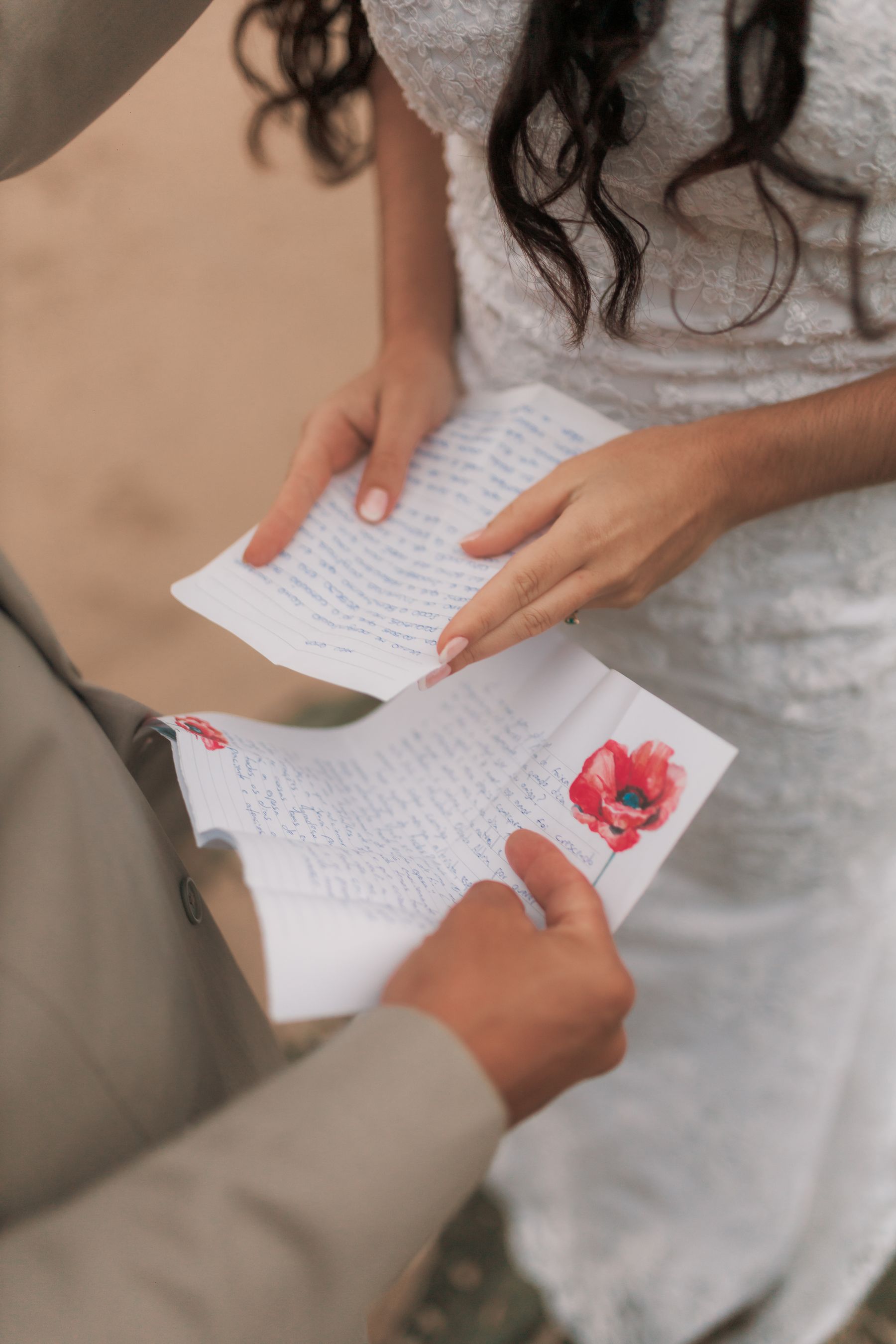 Bride and groom exchanging handwritten wedding vows